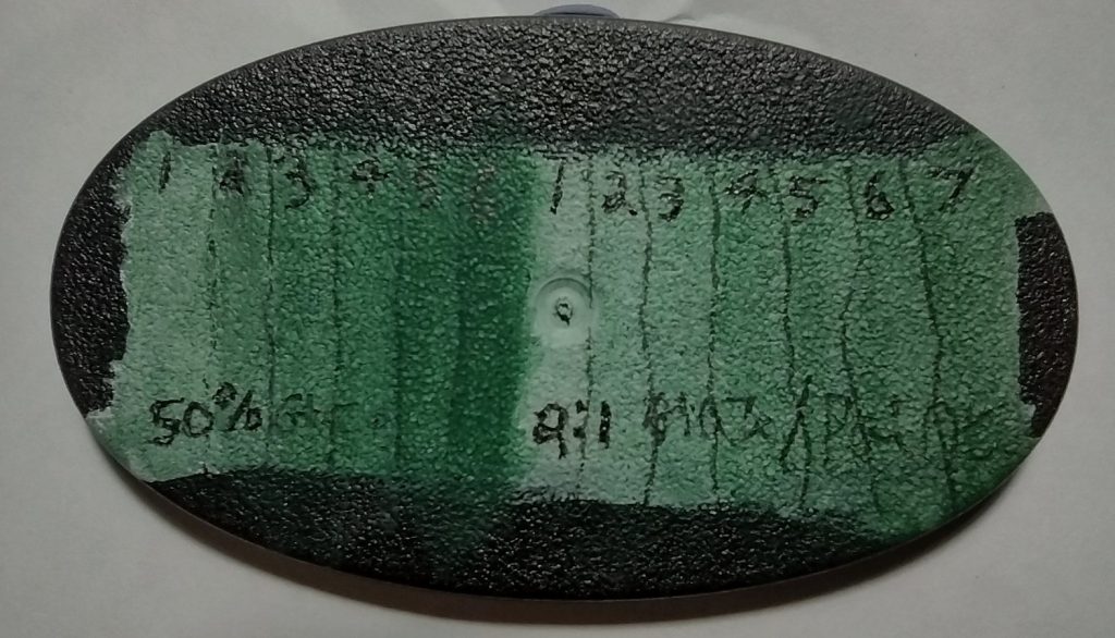 a  miniature base with successive layers of thinned paint