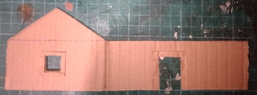 cardboard model cottage end and side with doorway and window cut out