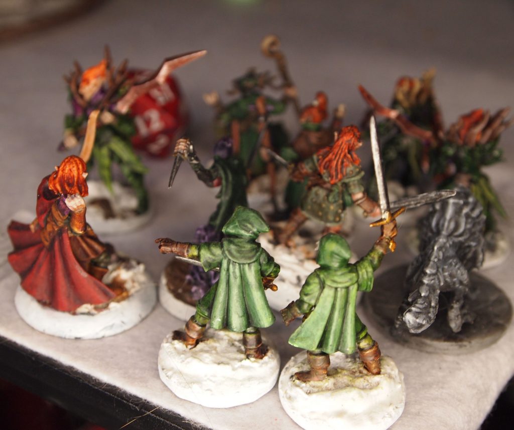 Miniatures for Frostgrave skirmish game clustered at the edge of the wargames table