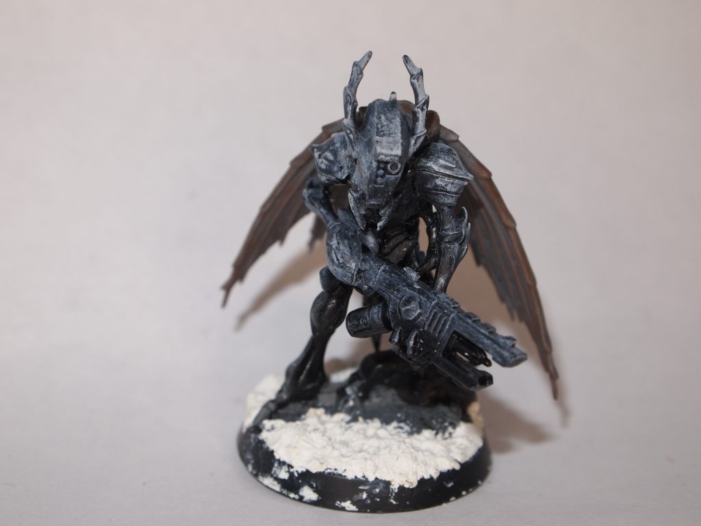 Vespid stingwing miniature primed with black paint and highlighted with grey and white