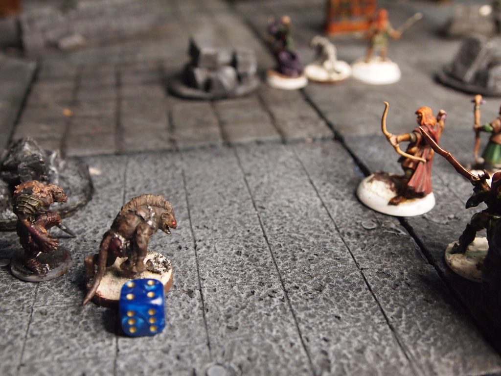 Miniatures on a wargames board for the Frostgrave skirmish wargame
