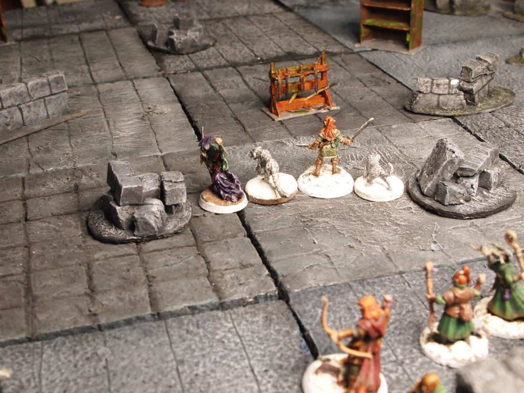 Miniatures on a wargames board for the Frostgrave skirmish game