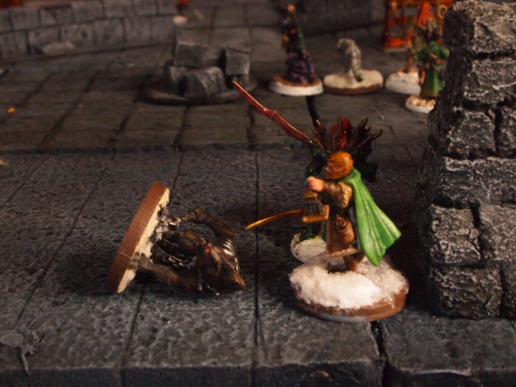 Miniatures on a a wargames board for the Frostgrave skirmish wargame