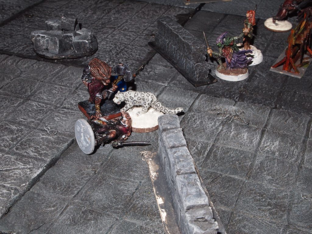 Snowleopard and gnoll miniatures in a game of Frostgrave