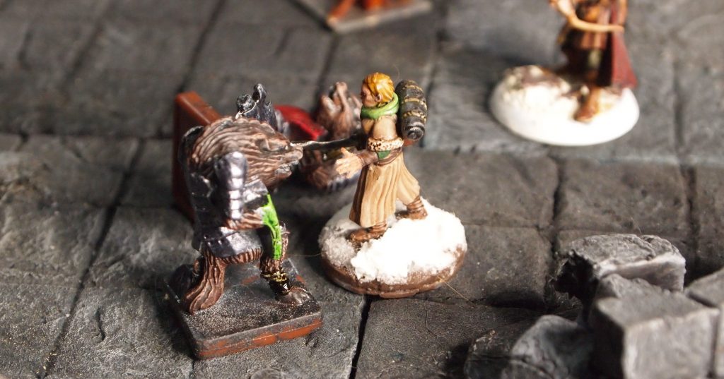 Miniatures on a a wargames board for the Frostgrave skirmish wargame