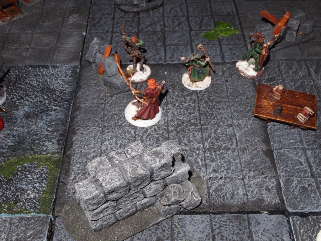Miniatures on a wargames table for the Frostgrave skirmish wargame