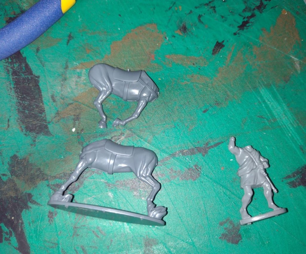 Two parts of a horse body miniature and a greek peltast without head and right arm.