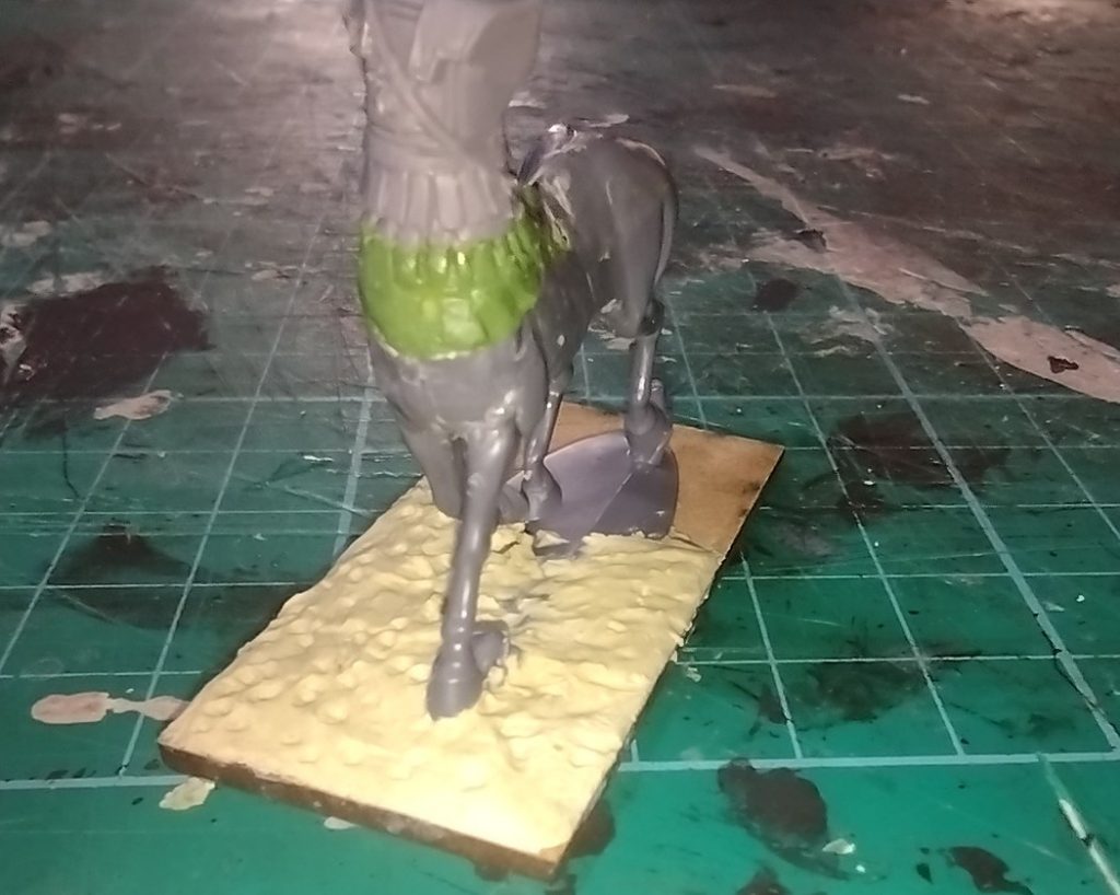 Kit-bashed centaur with armoured sparten hoplite for the human torso part and a row of green stuff expoxy putty sculpted armour.