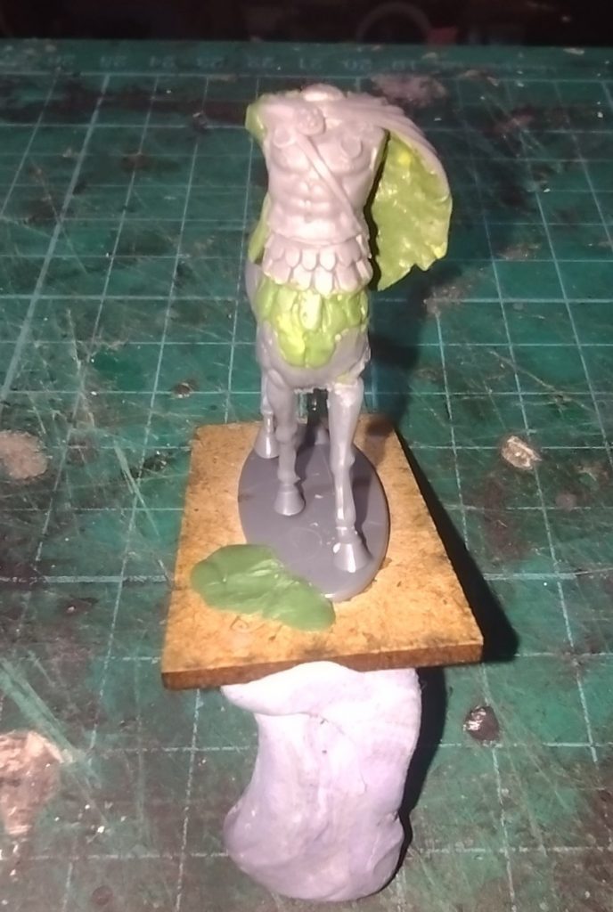 Front view of kit-bashed centaur miniature with a greenstuff cloak added.